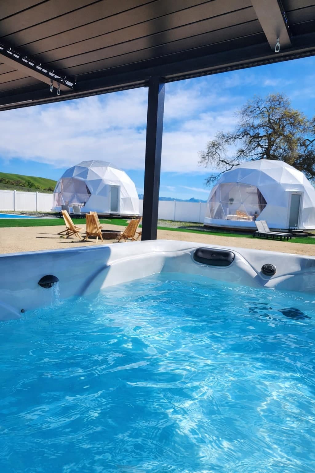 Heated jacuzzi overlooking the geodesic domes and hills at the private estate