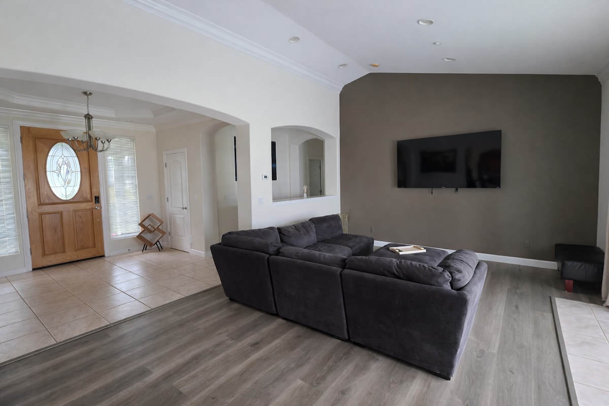 Main house living room with sectional and entryway