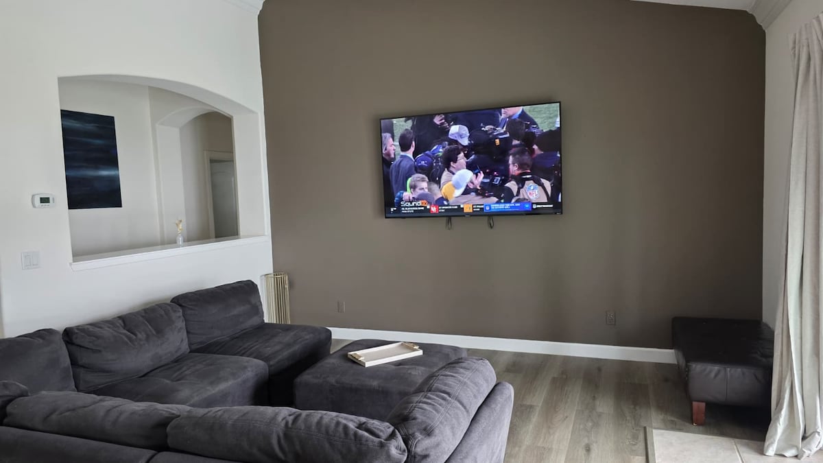 Living room with sectional and large TV