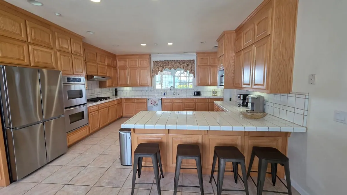 Gourmet kitchen with island and bar stools