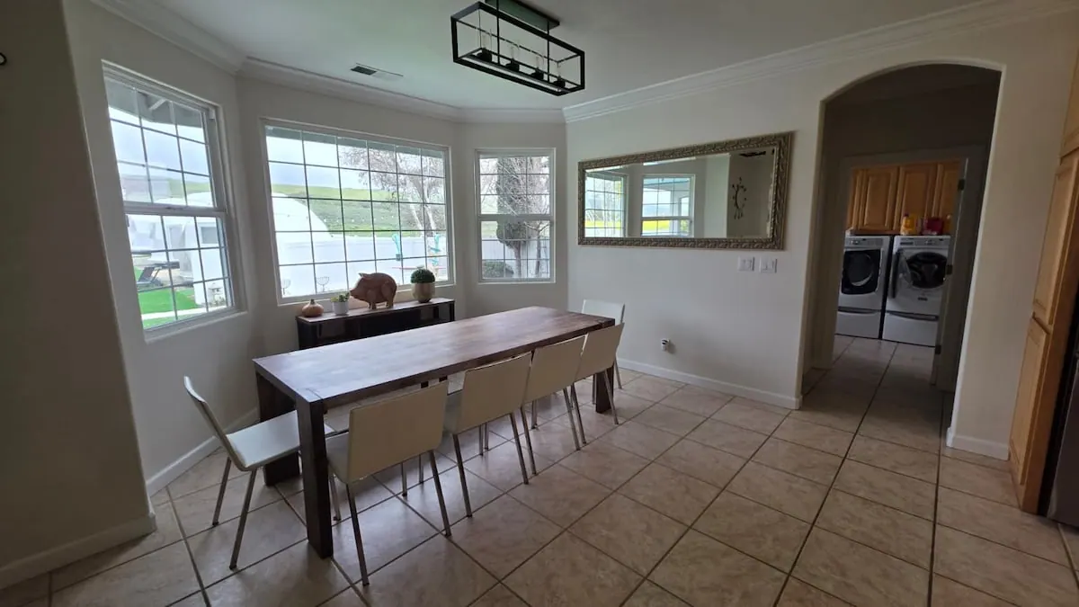 Dining area with long table and bay windows