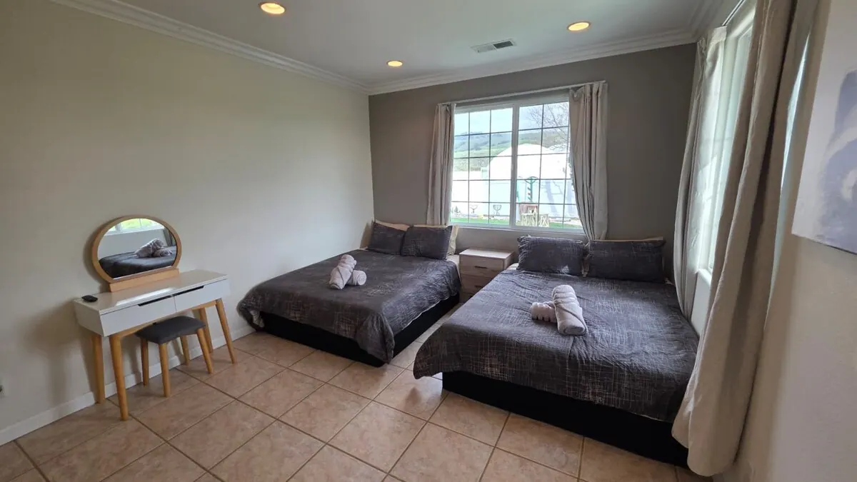 Bedroom with two beds and a vanity