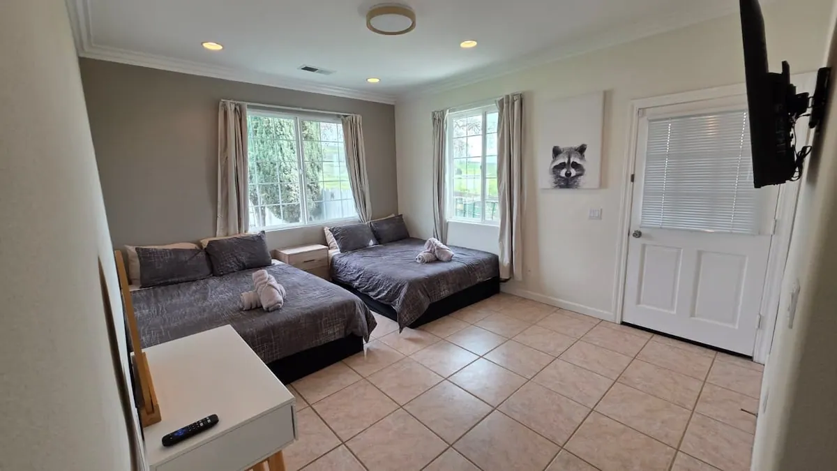 Bedroom with two beds and wall artwork