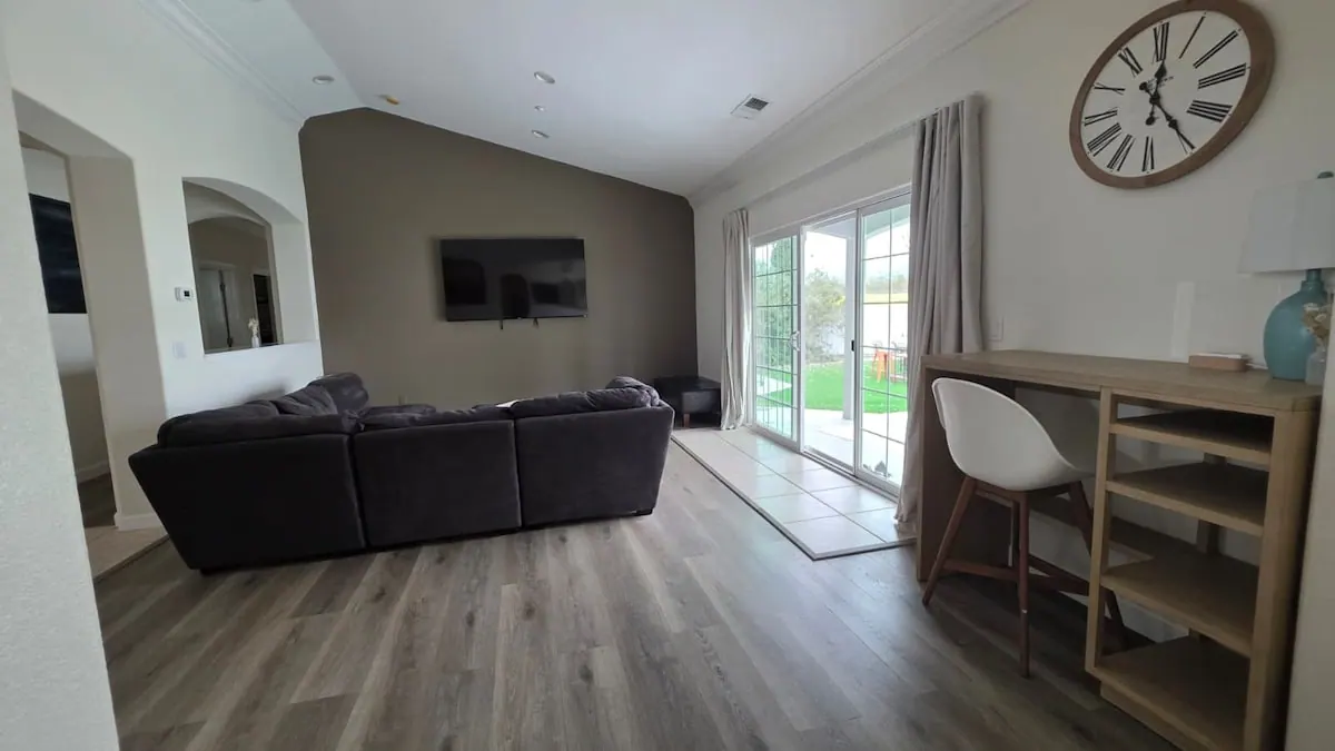 Living room with sectional, desk and patio doors